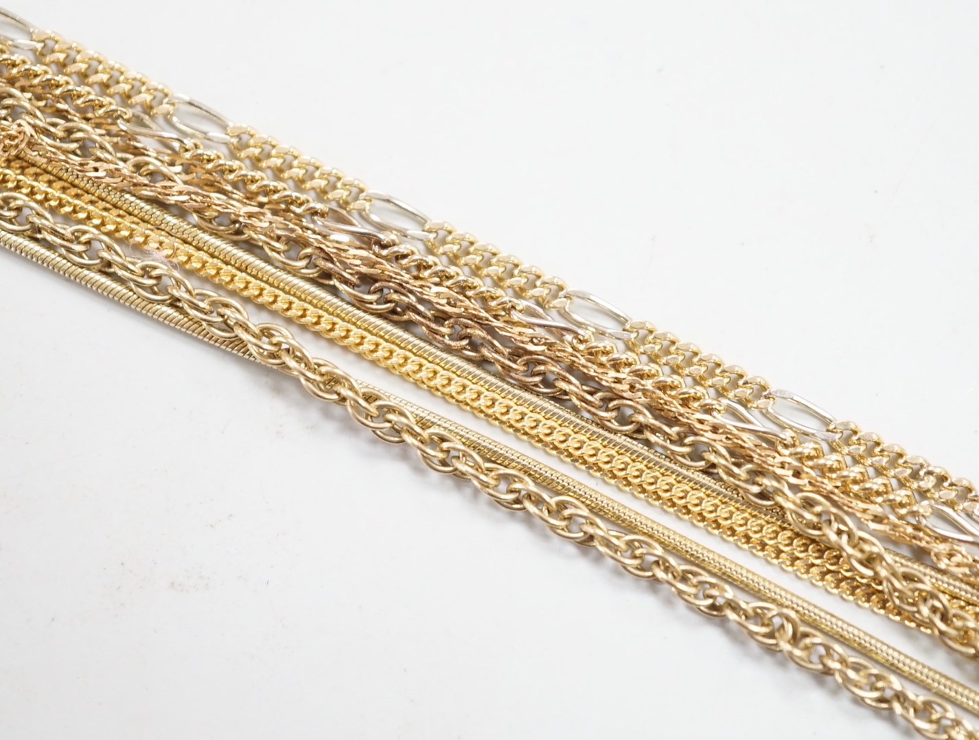 Five assorted modern 9ct gold chains including one two colour, longest 55cm, 16.6 grams.